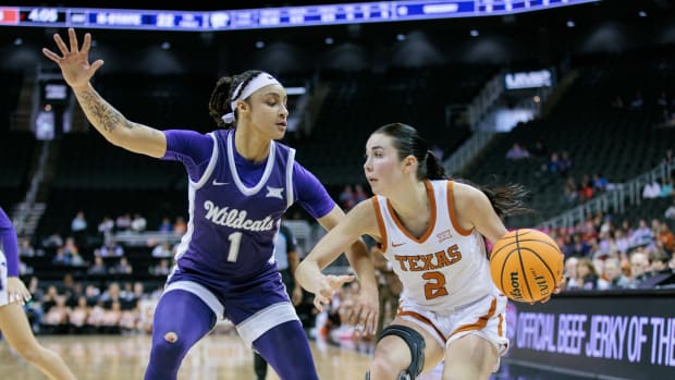 Mar 11, 2024; Kansas City, MO, USA; Texas Longhorns guard Shaylee Gonzales (2) drives to the basket around Kansas State Wildcats guard Zyanna Walker (1) during the first half at T-Mobile Center.
